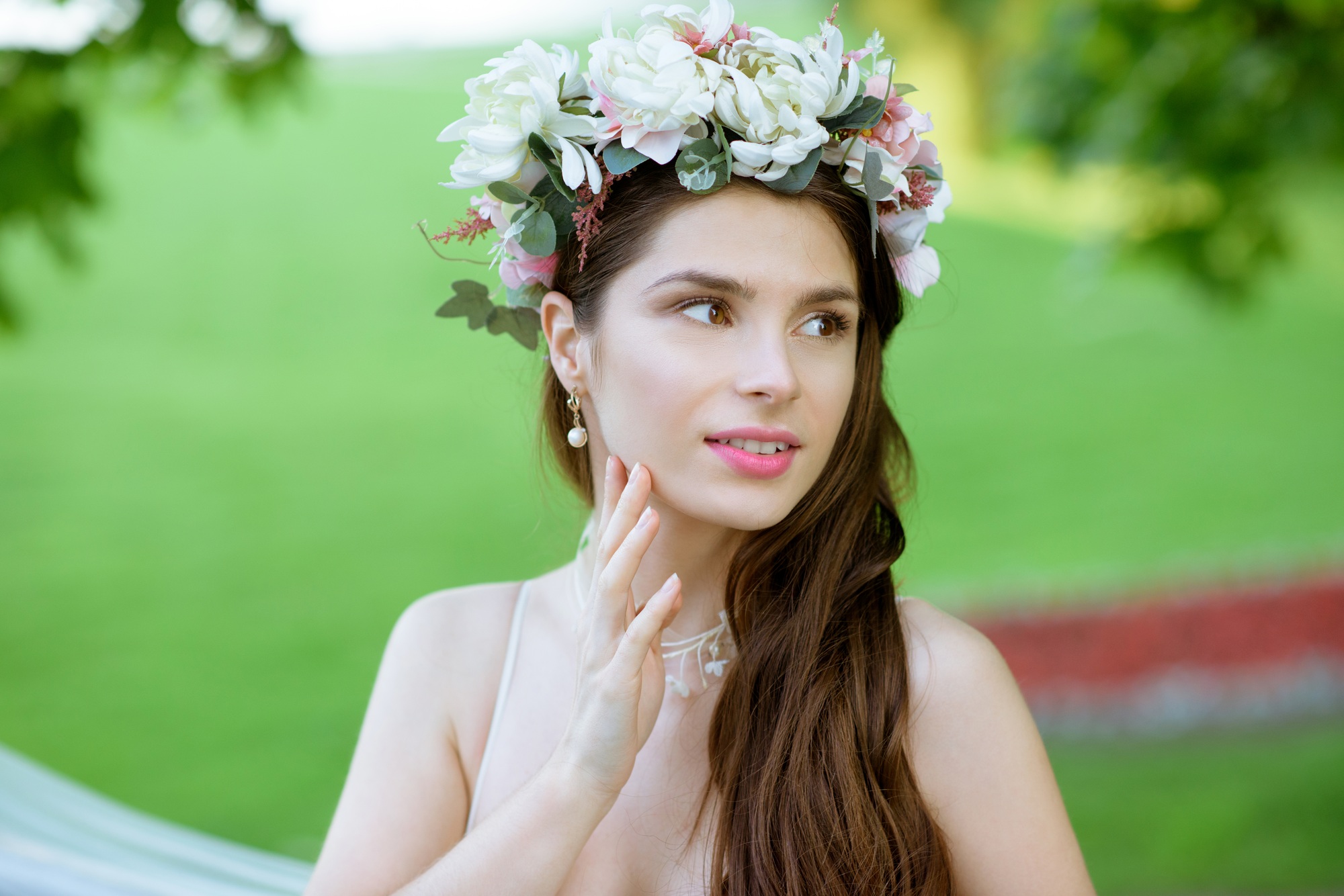 Closeup brunette bride with fashion wedding hairstyle and makeup.