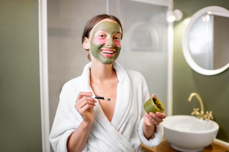 Woman with facial mask and patches in the bathroom